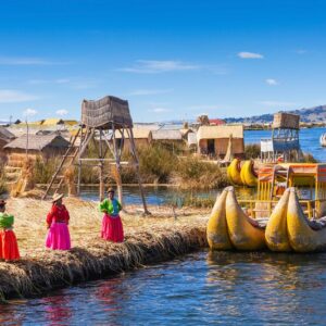 PUNO, PERU - MAY 14, 2015: Unidentified women in traditional dresses welcome tourists in Uros Island.